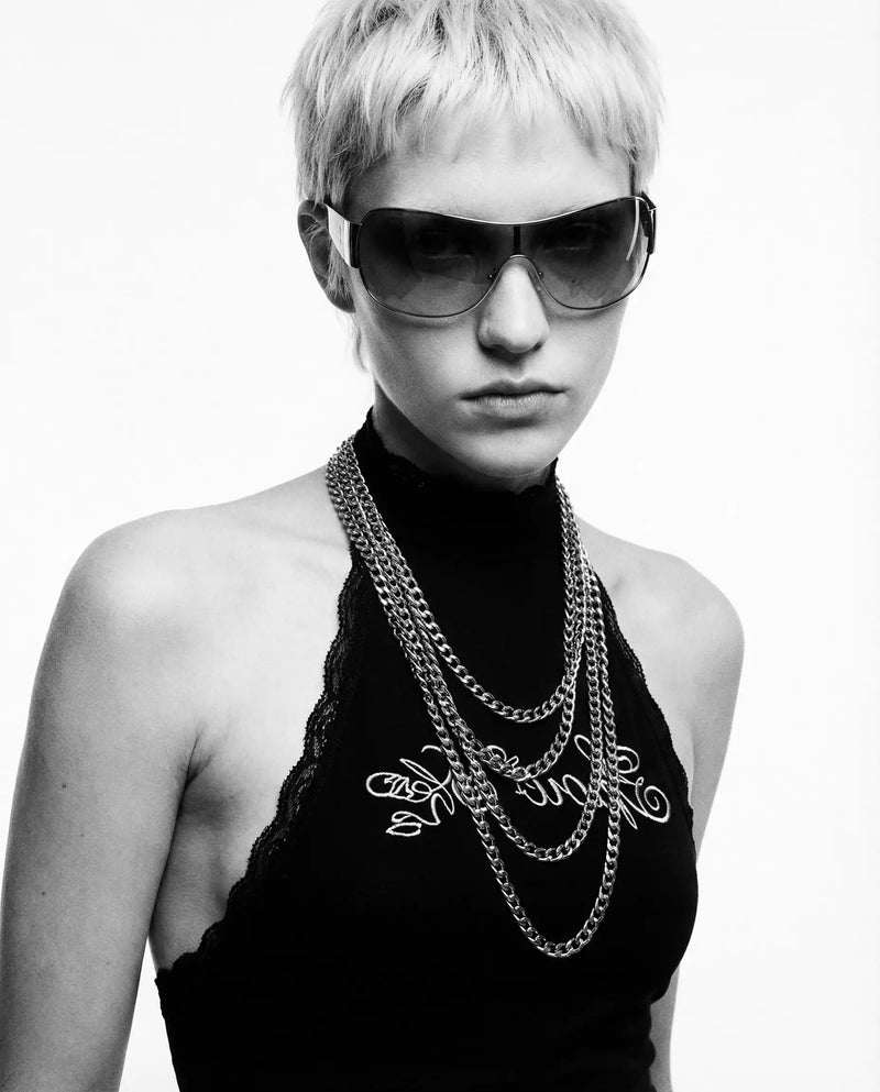monochrome editorial Y2K model with black top and layered chains